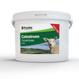 White plastic bucket of provita lamb colostrum concentrate with green label featuring lamb image for newborn lambs