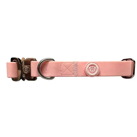 A sleek pastel pink puppy pvc btactical collar made of leather with a sturdy metal buckle and brand emblem