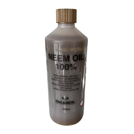 A clear plastic bottle of pure neem oil with a gold ribbed cap labeled 500ml for external use and fly repellents