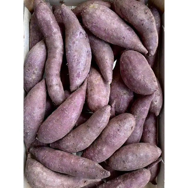 A box filled with fresh purple sweet potatoes perfect for cooking or snacks rich in natural color and flavor