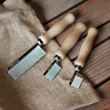 Three wooden handled metal grooming quarter marking combs with silver teeth for smart quarter marking use