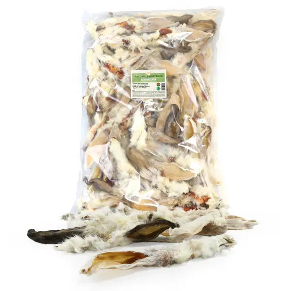 A clear plastic bag filled with light beige and white rabbit ears with fur 2kg suitable for equestrian use