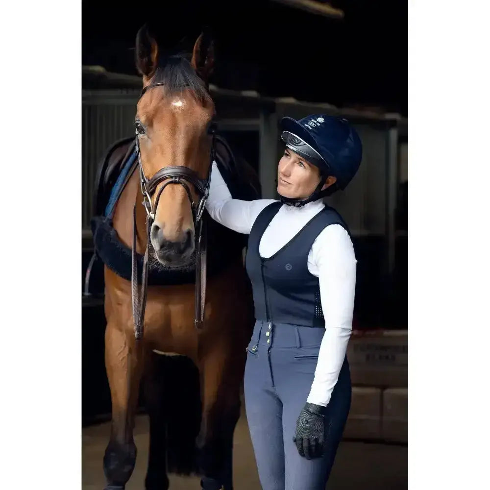 Dark blue racesafe motionlite equestrian helmet with subtle logo designed as a protector young rider technical gilet accessory