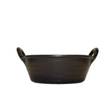 Black plastic gorilla plas feed skip with two looped handles and ribbed texture for easy carrying