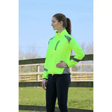 Bright neon green reflector jacket by hy equestrian with black zippers for darker evenings wearing reflective jacket