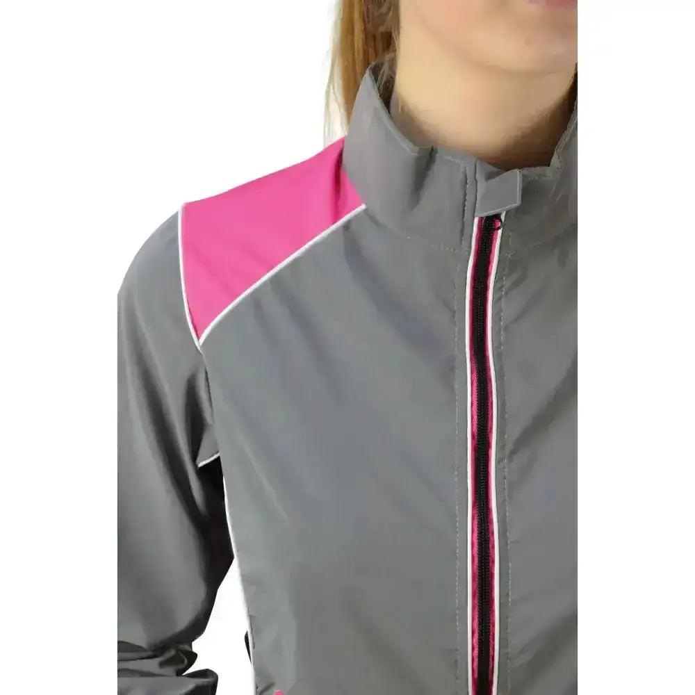 Gray and pink reflector jacket by hy equestrian with white trim designed for darker evenings wearing and safety