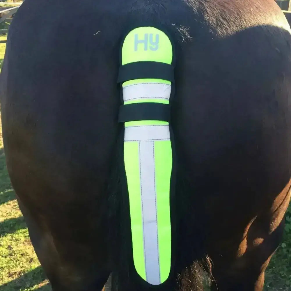 Bright neon green and black reflector tail guard by hy equestrian with white stripes touch tape fastenings fleece underside