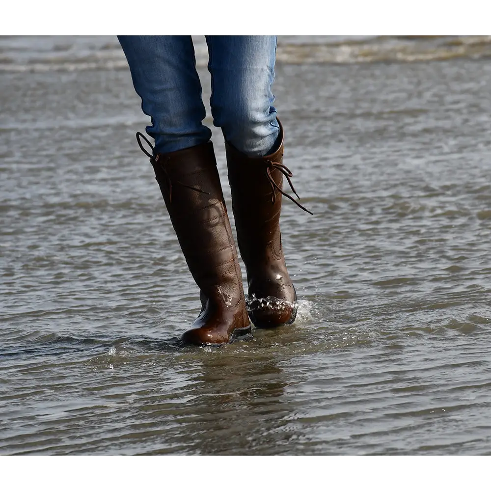 Brown leather Rhinegold Beaumont Country Boots in shallow water for outdoor adventures