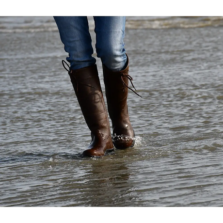 Brown leather Rhinegold Beaumont Country Boots in shallow water for outdoor adventures