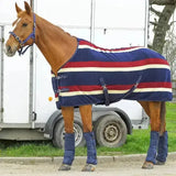 A horse wearing a navy blue red and cream striped rhinegold fleece rugs elite fleece rug with black straps