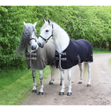 Two white horses wearing rhinegold fleece rugs elite in grey and black with quality anti-pill fleece material
