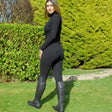 Black leather riding boots with smooth finish and tall shafts paired with rhinegold elite ladies thermal breeches