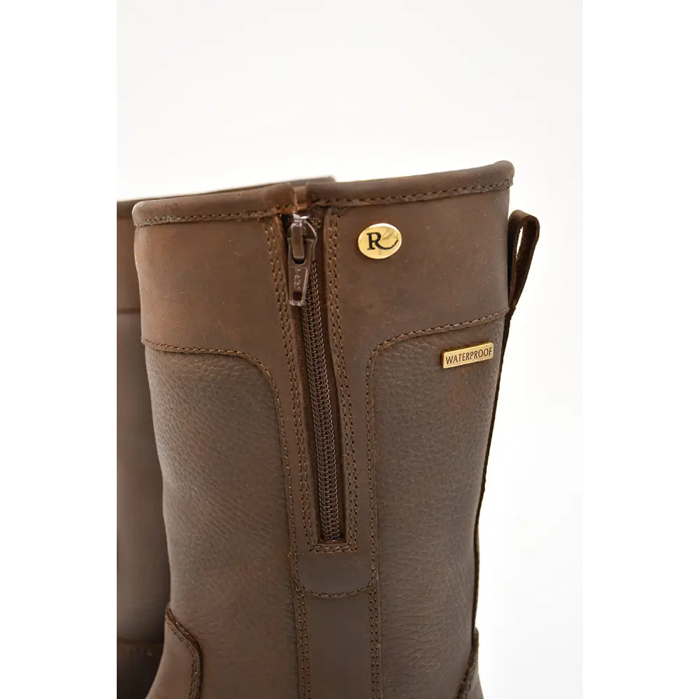 Brown leather boot with a side zipper and gold-colored hardware.