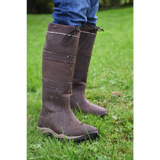 Pair of tall brown Rhinegold Harlem Leather Waterproof Country Boots on grass