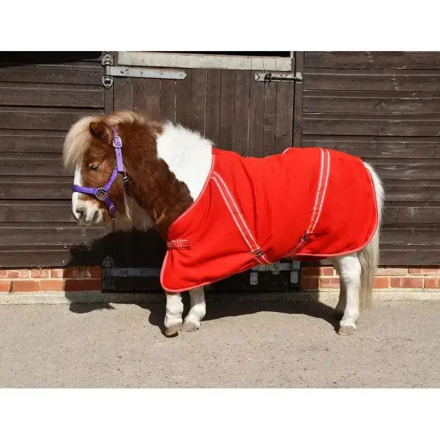 Red rhinegold mini fleece horse rug with white trim and adjustable straps for comfortable cosy fleece warmth