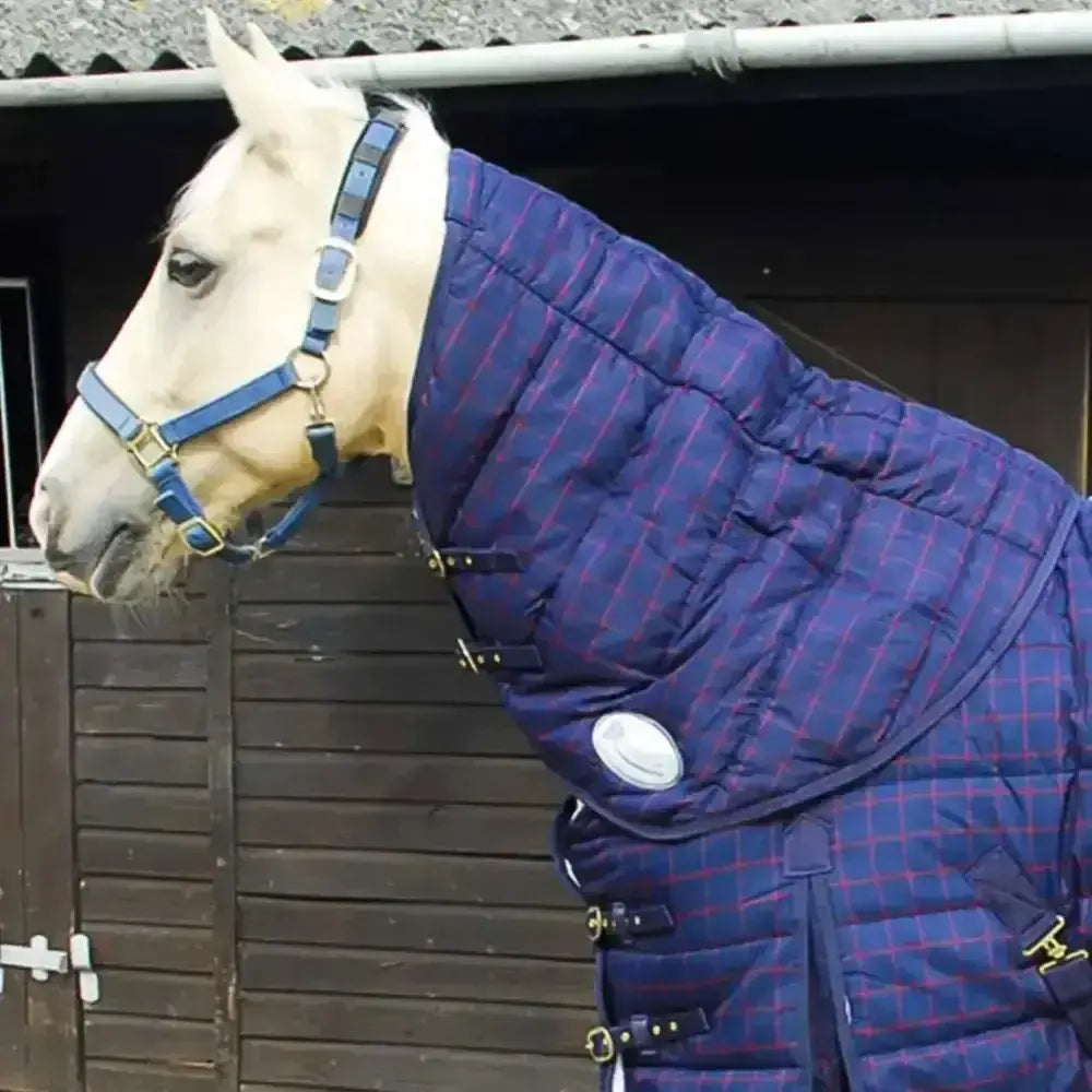 A navy blue and red plaid quilted rhinegold orlando neck cover with black straps and gold-toned buckles