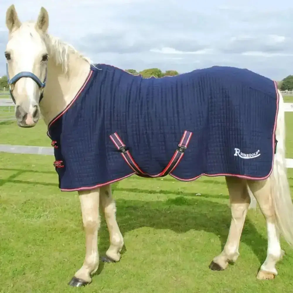 Navy blue quilted rhinegold premium tech cooler rug with red black trim and adjustable straps featuring rhinegold logo