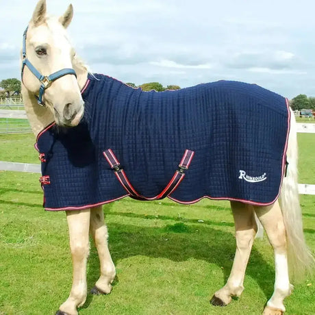Navy blue quilted rhinegold premium tech celltex cooler rug with red trim and black straps featuring rhinequus logo