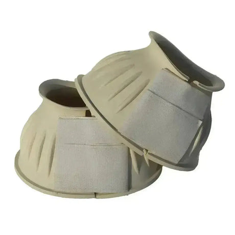 Beige rhinegold rubber reach boots with textured shells and padded gray straps for horses fetlock protection