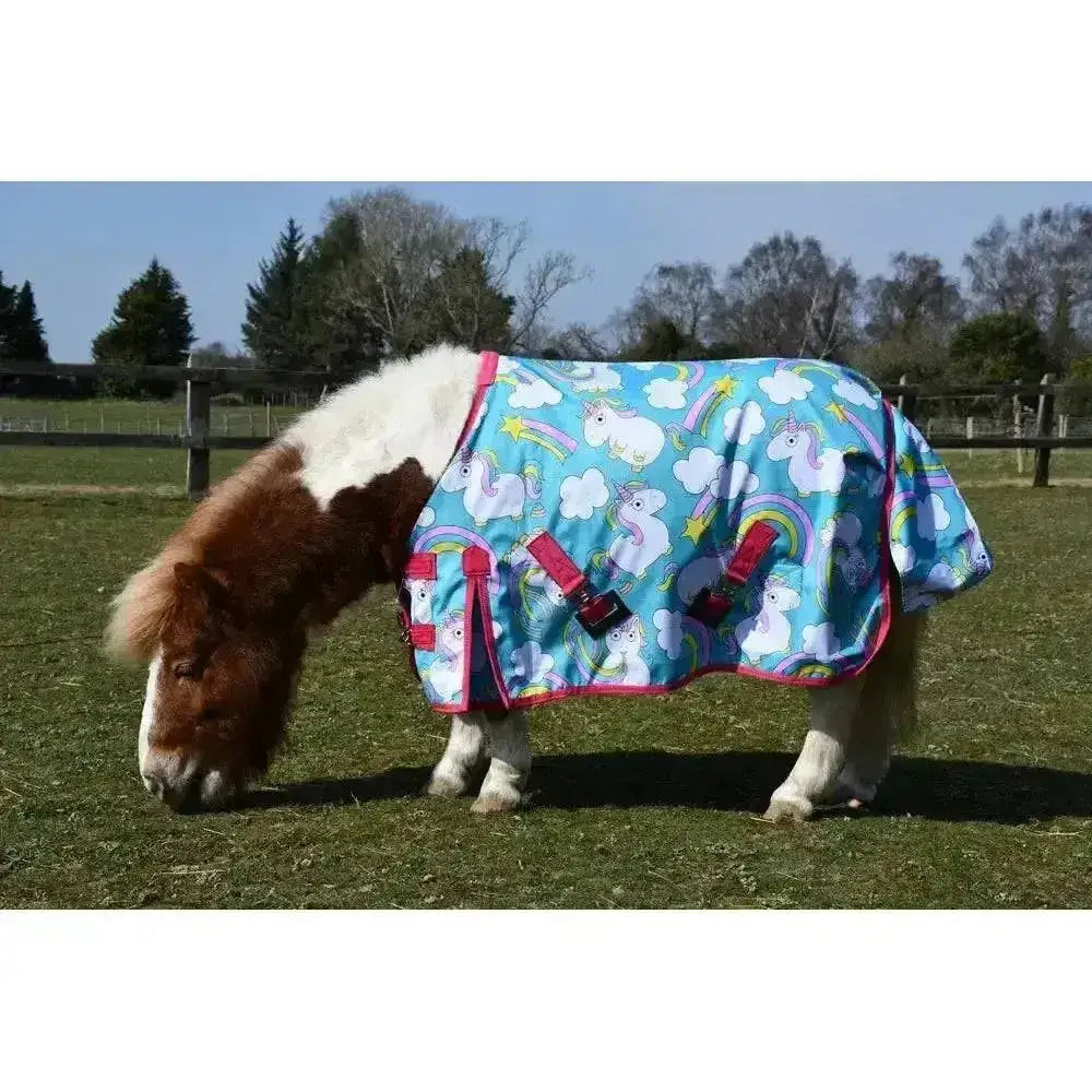 A vibrant blue rhinegold unicorn mini torrent outdoor rug with rainbow cloud patterns pink trim and red buckles
