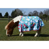 A vibrant blue rhinegold unicorn mini torrent outdoor rug with rainbow cloud patterns pink trim and red buckles