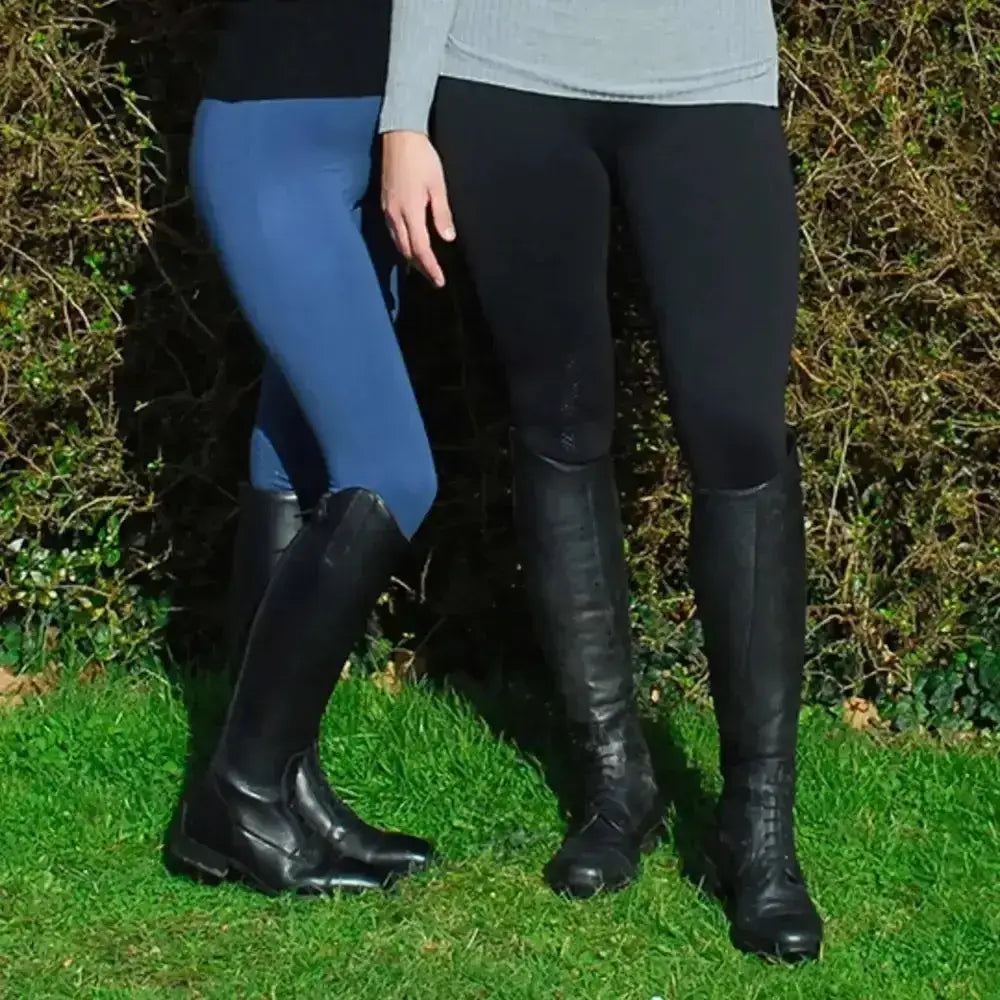 Black leather riding boots with glossy finish and lace-up design paired with rhinegold warmer weight riding tights