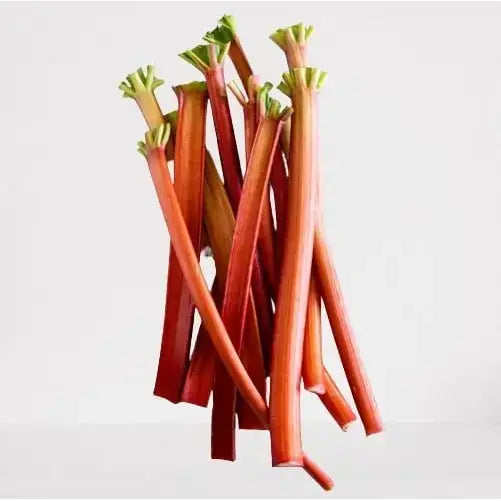 A vibrant red rhubarb bunch with fresh green leaves perfect for pairing with somerset strawberries or equestrian treats
