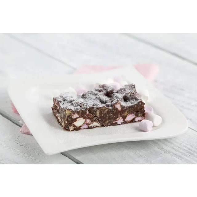 A square slice of chocolate rocky road with pink and white marshmallows dusted with powdered sugar made with wheat flour and invert sugar syrup