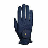 Navy blue roeckl chester grip summer riding gloves with small gold logo on wrist strap showing back side