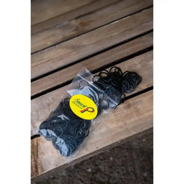 Black rubber plaiting bands in clear bag with yellow smart grooming label perfect for taming unruly manes