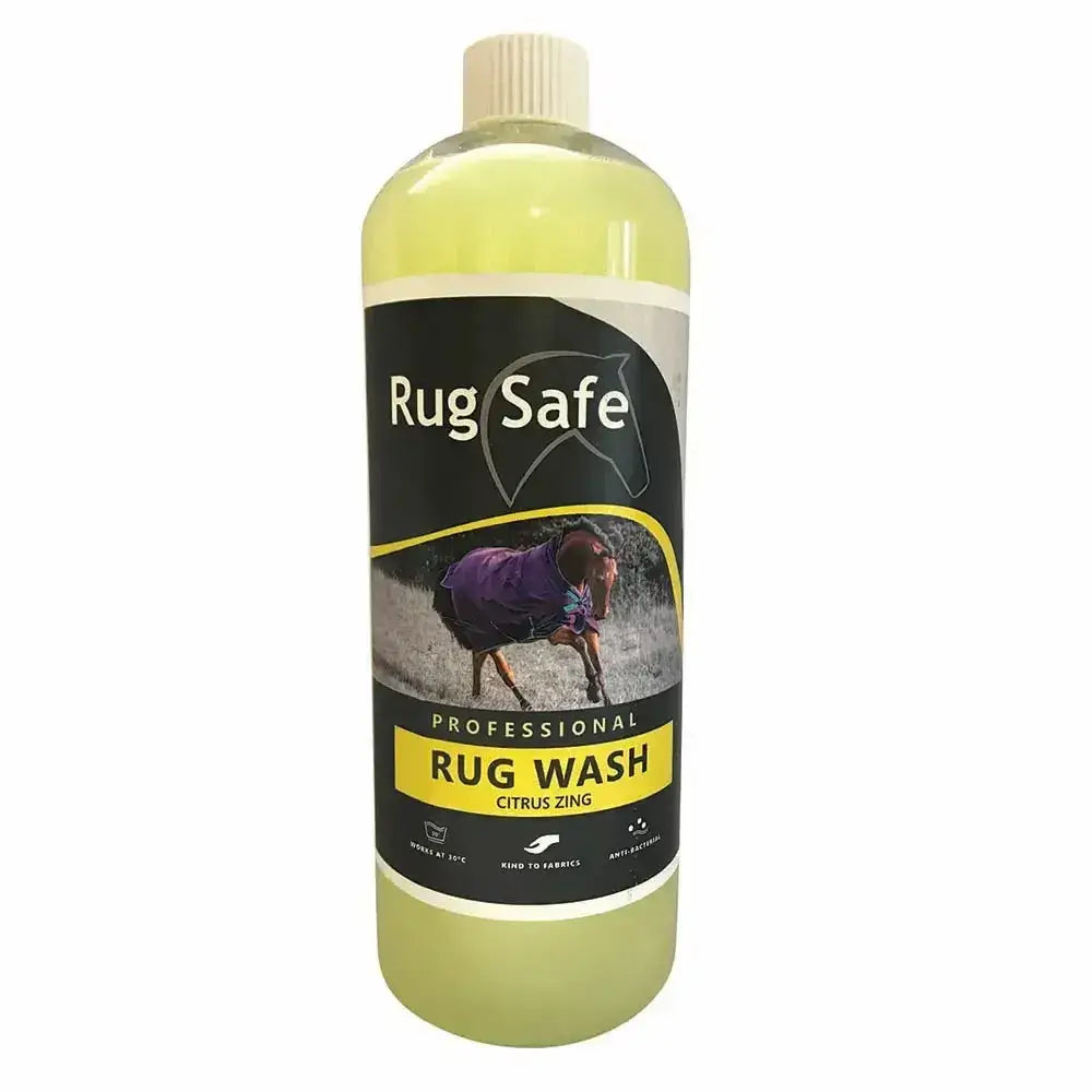 A clear plastic bottle of rugsafe citrus zing antibacterial rug wash with pale yellow liquid and black yellow label