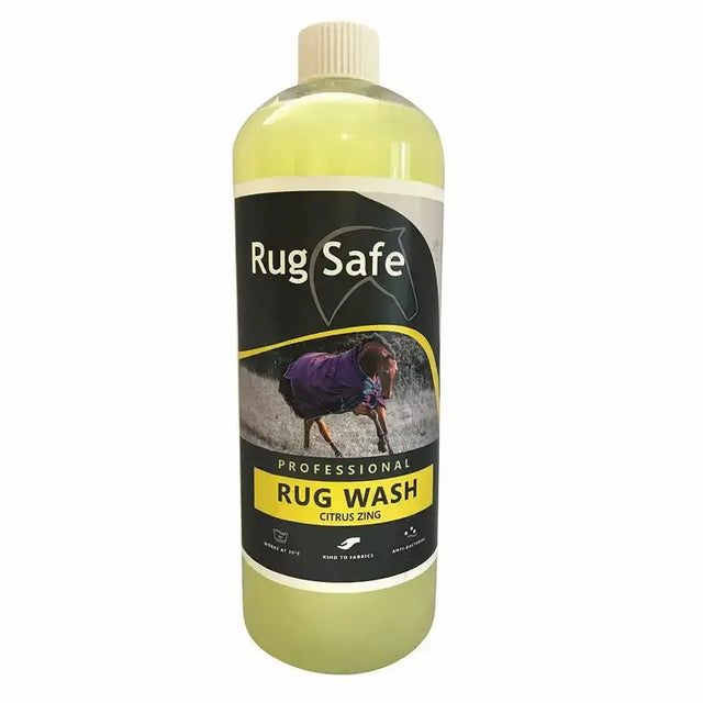 A clear plastic bottle of rugsafe citrus zing antibacterial rug wash with pale yellow liquid and black yellow label