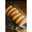 Golden-brown ryders bakery white finger rolls with soft texture on wooden board perfect for sandwiches or sides