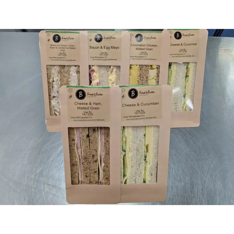 Packaged fresh sandwiches in beige cardboard sleeves with clear windows ideal for equestrian snack breaks