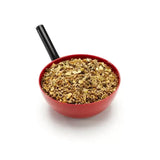 Red plastic measuring cup with black handle filled with saracen competition fit mix for performance horse’s fibre
