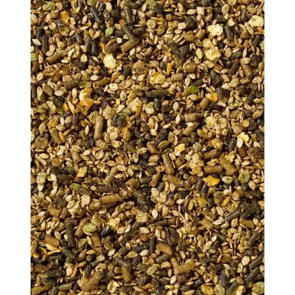 A mix of brown and green pelletized pony cooling mix with small grains scattered in saracen cooling mix for horses