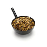 Black plastic measuring cup filled with brown tan mix of chelated minerals for equine athlete saracen enduro-performance