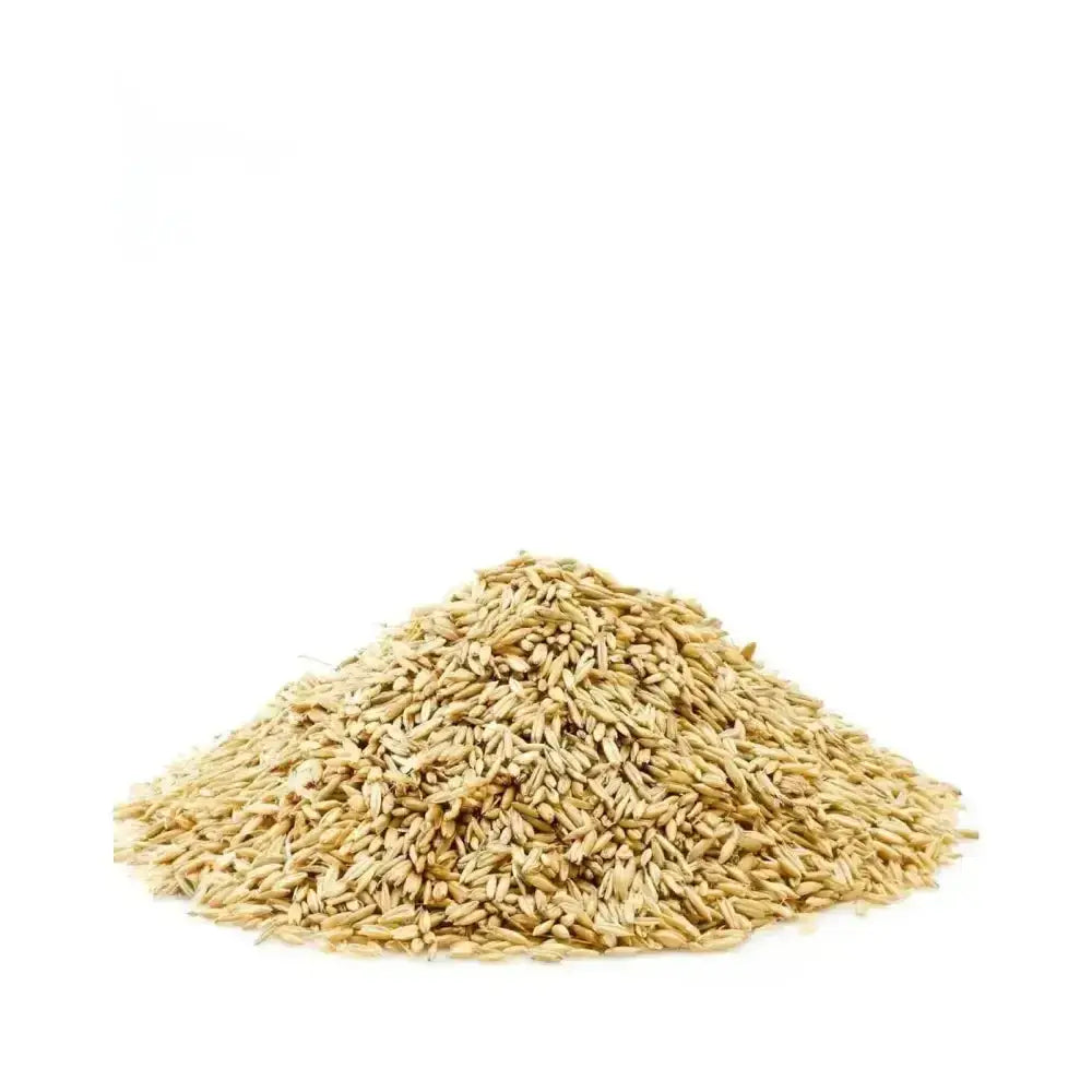 A mound of light brown saracen english bruised oats with a slightly rough texture perfect for cooking and baking