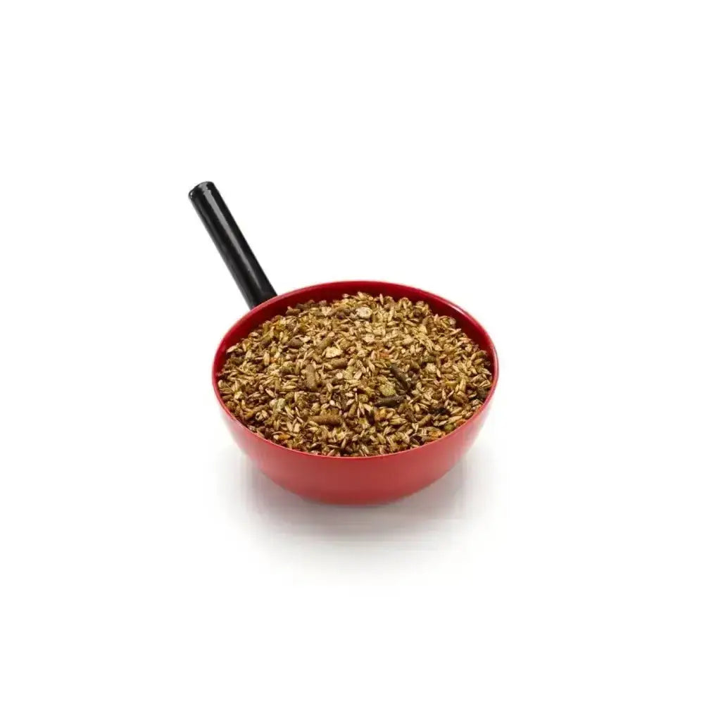 Red plastic measuring cup with black handle filled with brown saracen stud mix multipurpose traditional stud granular material