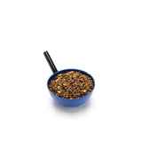 Blue ceramic measuring cup with black handle filled with cumin seeds for saracen stud prep buffered mineral complex use