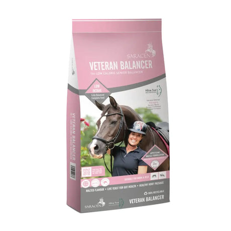 Pink and white bag of saracen veteran balancer horse feed with highly appetising muesli and low glycaemic coating next to smiling rider and dark brown horse