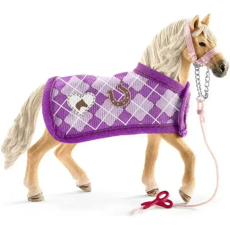 A schleich horse club toy horse with light tan body and purple argyle blanket from sofias fashion creation with horse accessories