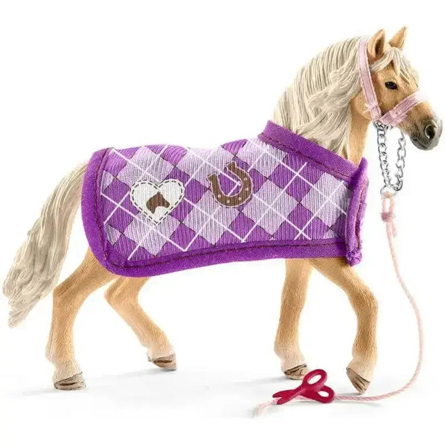 A schleich horse club toy horse with light tan body and purple argyle blanket from sofias fashion creation with horse accessories