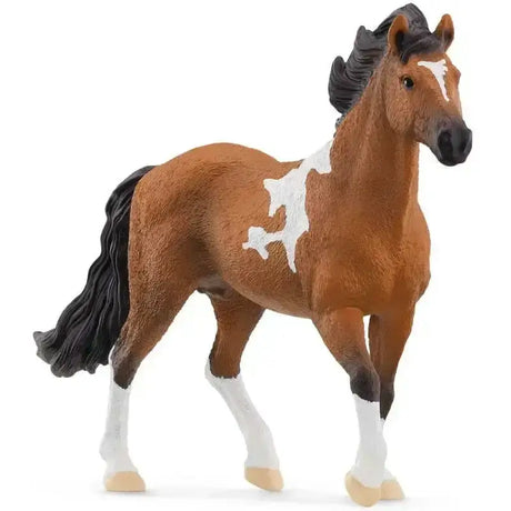 Detailed brown and white plastic model of a schleich mangalarga marchador stallion with black mane and hooves
