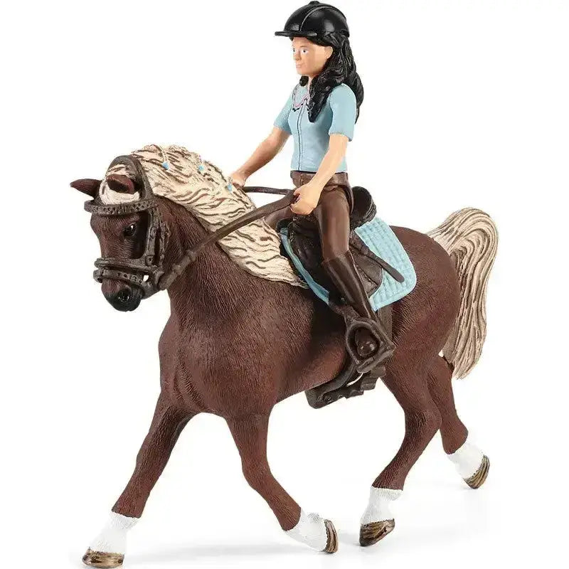 A detailed brown plastic horse figurine with rider wearing black helmet light blue shirt from schleich washing area horse club emily