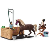 Brown plastic horse with blonde mane wearing purple halter in schleich washing area with horse club emily set