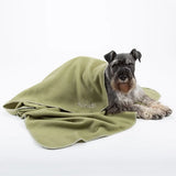 Olive green scruffs expedition fleece blanket with white stitched trim and embroidered scruffs logo on the corner