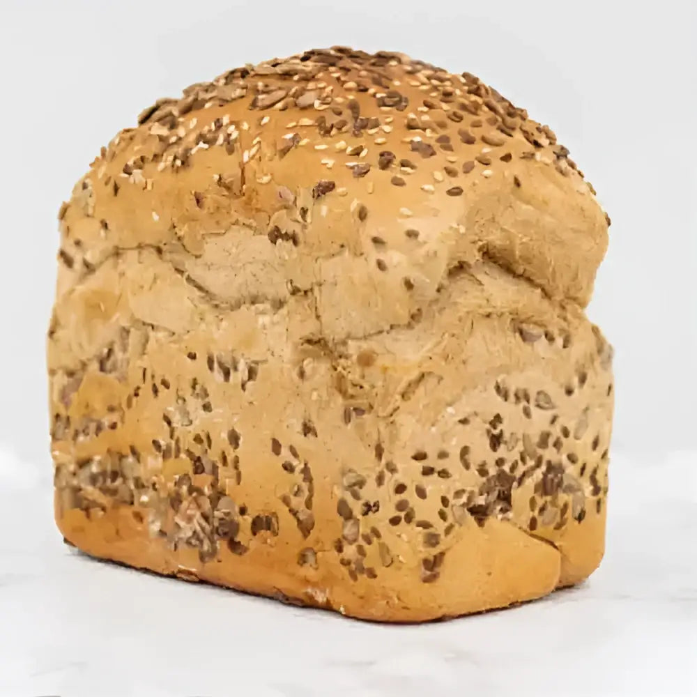 Golden-brown seeded rye bread round loaf topped with sesame and dark seeds perfect for sandwiches or toast