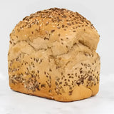 Golden-brown seeded rye bread round loaf topped with sesame and dark seeds perfect for sandwiches or toast
