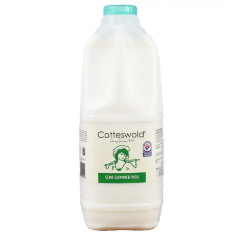 A white plastic bottle of cotteswold semi skimmed milk with a teal cap and green vintage label for milk cotteswold